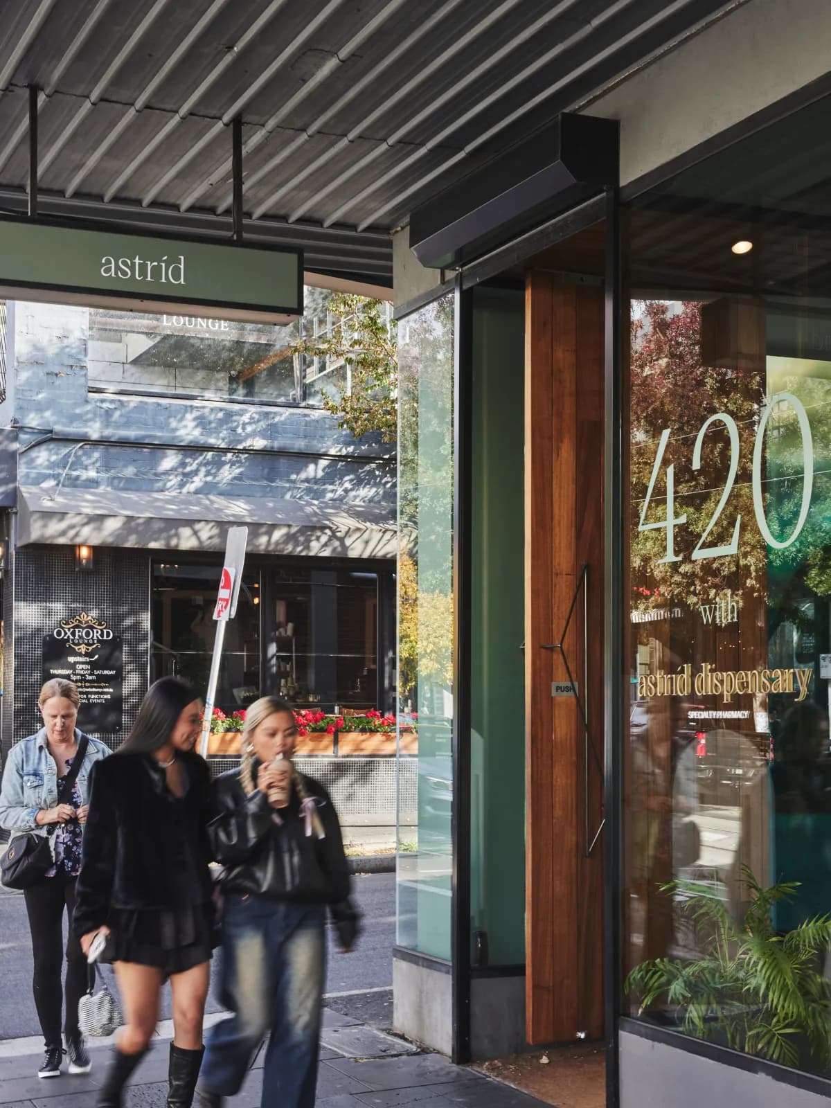 An image of the outside of astrid dispensary in Melbourne with people walking past