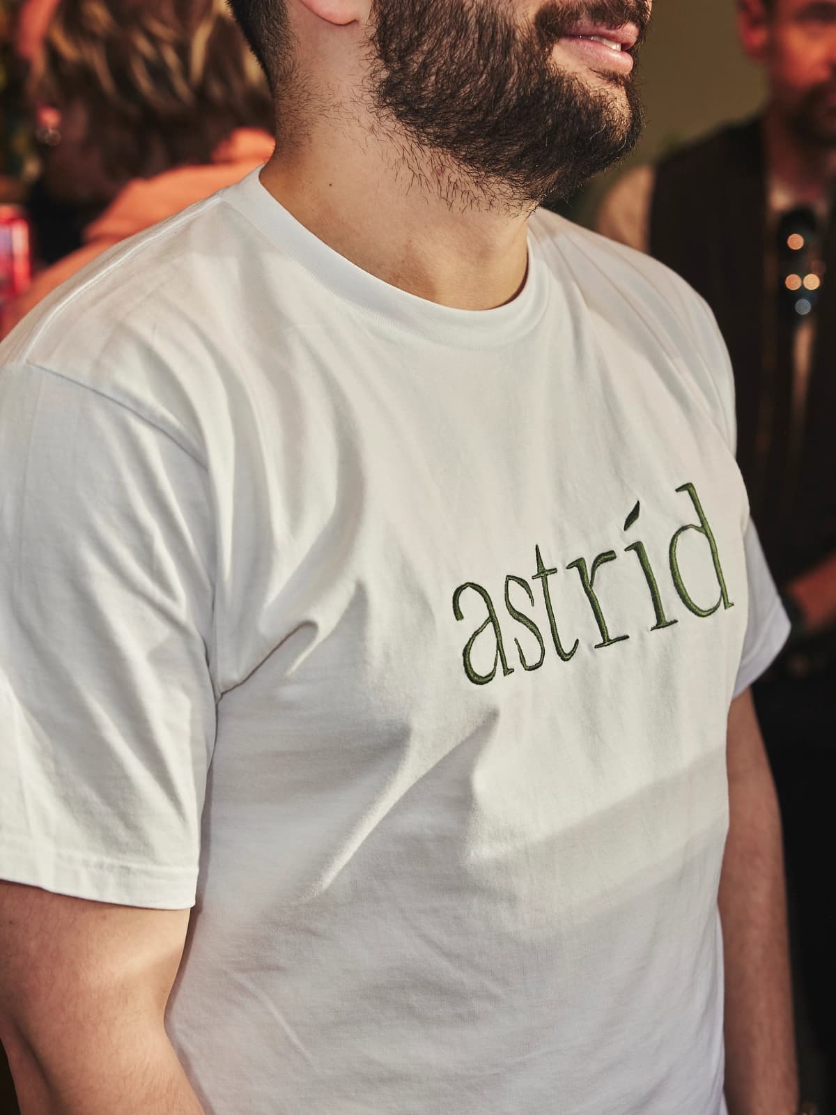 An astrid staff member wearing an astrid branded white tshirt