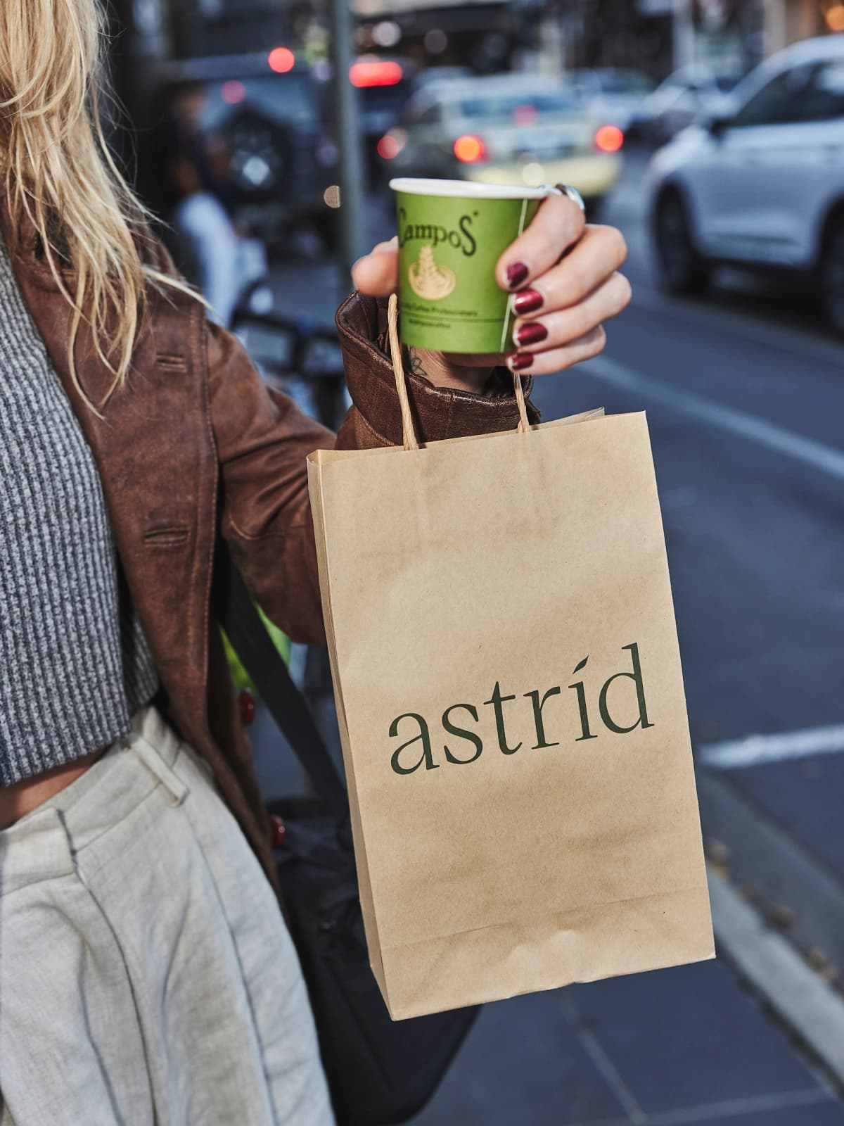 A close up of a astrid branded paper bag being held outside astrid dispensary in Melbourne