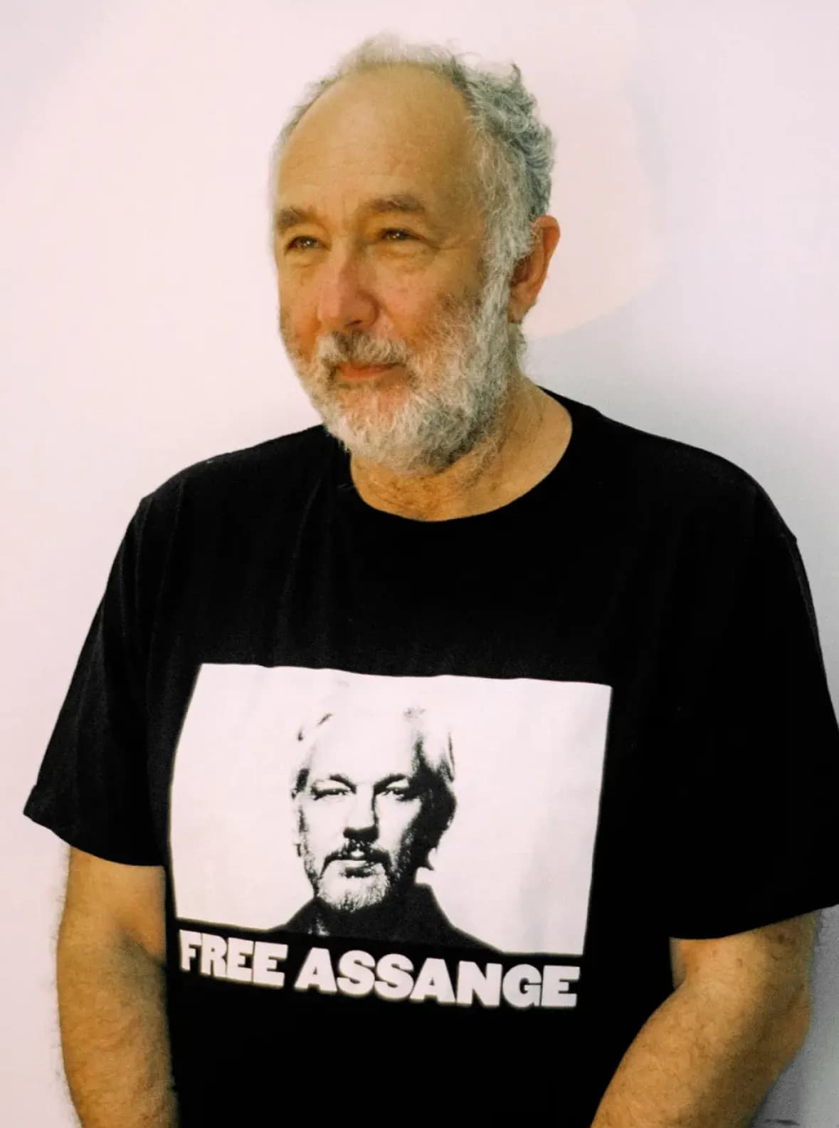 A portrait of David Heiplpern, wearing a black tshirt infront of a white background