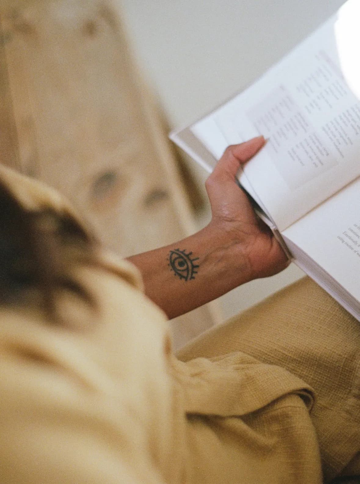 A close up on a person holding a book in their hands and reading